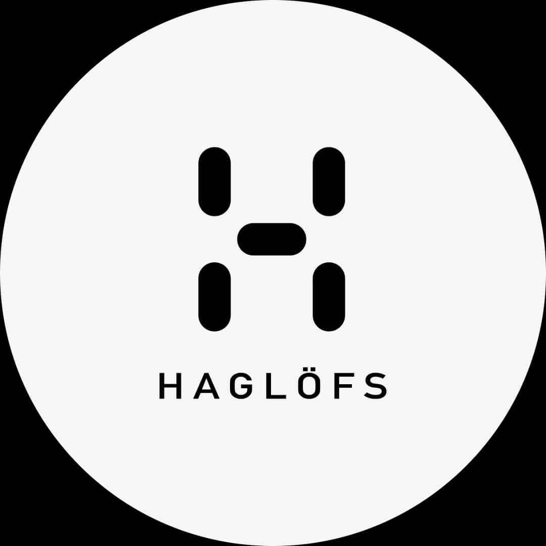 Svart stiliserat "H" med texten "Haglöfs" under, på vit cirkulär bakgrund.